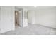 Bedroom with neutral walls and carpet and view of the ensuite bathroom and closet at 9424 Lexington Cir # F, Charlotte, NC 28213