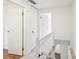 Upstairs hallway featuring a wood floor and a white banister with spindles at 9424 Lexington Cir # F, Charlotte, NC 28213