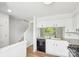 Bright kitchen features white cabinets, granite countertops and black appliances at 9424 Lexington Cir # F, Charlotte, NC 28213