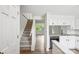 Open kitchen features granite countertops, black appliances, and hardwood flooring at 9424 Lexington Cir # F, Charlotte, NC 28213