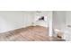 Living room with view of the kitchen and wood-look flooring at 9424 Lexington Cir # F, Charlotte, NC 28213