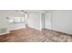 Living room with view of the kitchen and wood-look flooring at 9424 Lexington Cir # F, Charlotte, NC 28213