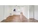 Living room with view of the kitchen and wood-look flooring at 9424 Lexington Cir # F, Charlotte, NC 28213