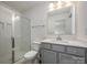 Modern bathroom with a glass-enclosed shower and gray vanity with white countertop at 13047 Gadwal Pintail Dr, Charlotte, NC 28262