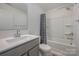 Well-lit bathroom with a shower-tub combo, gray vanity, and stylish fixtures at 13047 Gadwal Pintail Dr, Charlotte, NC 28262