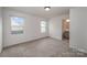 Bright bedroom with neutral carpet, white walls and two windows at 13047 Gadwal Pintail Dr, Charlotte, NC 28262