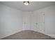 Neutral bedroom showcasing carpet, white walls and two doors for accessibility at 13047 Gadwal Pintail Dr, Charlotte, NC 28262