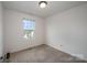 Cozy bedroom with neutral carpet, white walls, and a bright window at 13047 Gadwal Pintail Dr, Charlotte, NC 28262