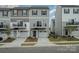 Modern townhome featuring a small balcony and a single-car garage in a residential neighborhood at 13047 Gadwal Pintail Dr, Charlotte, NC 28262