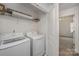 Convenient laundry room with modern washer and dryer units, and shelving at 13047 Gadwal Pintail Dr, Charlotte, NC 28262