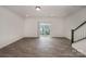 View of the living room with wood-look flooring and staircase at 13047 Gadwal Pintail Dr, Charlotte, NC 28262