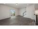 Living room with wood-look flooring and sliding door to balcony at 13047 Gadwal Pintail Dr, Charlotte, NC 28262