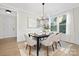 Bright dining room with hardwood floors, a dark wood table, and six chairs at 2304 Catalina Ave, Charlotte, NC 28206