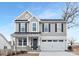 Two-story house with gray siding, metal roof, and a two-car garage at 2304 Catalina Ave, Charlotte, NC 28206