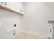 Laundry room with white cabinets and built-in storage at 2304 Catalina Ave, Charlotte, NC 28206