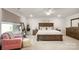 Main bedroom with king bed, armchair, and large window with blinds at 3878 Fairlady Ln, Fort Mill, SC 29707