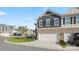 Two-story townhome with a two-car garage and stone accents at 3878 Fairlady Ln, Fort Mill, SC 29707