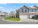 Two-story townhome with gray siding, two-car garage, and landscaping at 3878 Fairlady Ln, Fort Mill, SC 29707