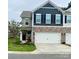 Two-story townhome with a two-car garage and stone accents at 3878 Fairlady Ln, Fort Mill, SC 29707