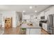 Kitchen with granite island, white cabinets, and hardwood floors at 3878 Fairlady Ln, Fort Mill, SC 29707