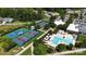Aerial view of community amenities including tennis courts and a large swimming pool with ample seating at 6296 Raven Rock Dr # 725, Denver, NC 28037