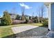 A backyard featuring a stone patio with landscaping and a black metal fence on a sunny day at 6296 Raven Rock Dr # 725, Denver, NC 28037