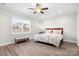 Bright bedroom with wood look floors, window, and a small bench at 6296 Raven Rock Dr # 725, Denver, NC 28037