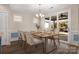 Bright dining area featuring modern lighting and sliding glass doors leading to an outdoor space at 6296 Raven Rock Dr # 725, Denver, NC 28037