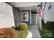 Inviting covered porch with brick accents and a glimpse of the home's exterior at 6296 Raven Rock Dr # 725, Denver, NC 28037