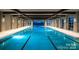Indoor swimming pool with lane markers and ample natural light, perfect for year-round swimming at 6296 Raven Rock Dr # 725, Denver, NC 28037