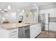 Kitchen island featuring a stainless steel dishwasher, undermount sink, granite countertops, and pendant lighting at 6296 Raven Rock Dr # 725, Denver, NC 28037