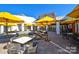 A well-designed outdoor patio area with tables, chairs, and umbrellas, perfect for relaxation at 6296 Raven Rock Dr # 725, Denver, NC 28037