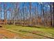 Spacious backyard with a wooden deck and a tree-filled landscape at 797 Chief Thomas Rd, Harmony, NC 28634