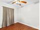 Simple bedroom with wood floors, ceiling fan, and neutral walls at 797 Chief Thomas Rd, Harmony, NC 28634