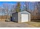 Detached garage with large door and gravel parking at 797 Chief Thomas Rd, Harmony, NC 28634