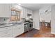 Modern kitchen with white cabinets and stainless steel appliances at 797 Chief Thomas Rd, Harmony, NC 28634