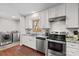 Modern kitchen with white cabinets and stainless steel appliances at 797 Chief Thomas Rd, Harmony, NC 28634