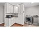 Laundry room with white cabinets and stainless steel washer and dryer at 797 Chief Thomas Rd, Harmony, NC 28634