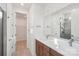 Modern bathroom boasts double sinks, white countertops, and a sleek glass-enclosed shower at 817 Terra Dr, Tega Cay, SC 29708