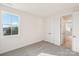 Light filled bedroom with neutral carpet, window and access to the hallway at 817 Terra Dr, Tega Cay, SC 29708