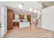 Open-concept living area featuring a kitchen island, staircase, and abundant natural light at 817 Terra Dr, Tega Cay, SC 29708