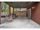 Covered patio area featuring a sliding glass door, lighting, a fenced area, and outdoor seating at 914 Wyke Rd, Shelby, NC 28150