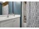 Cozy bathroom featuring a white vanity and a tub shower with a floral curtain at 914 Wyke Rd, Shelby, NC 28150