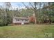 Exterior view of home with front lawn, landscaping and tree providing a view from the side of the home at 914 Wyke Rd, Shelby, NC 28150