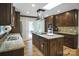 Spacious kitchen with dark wood cabinets, stainless steel appliances, and an island cooktop at 914 Wyke Rd, Shelby, NC 28150