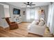 Bright living room with hardwood floors, white sofa, and large windows providing natural light at 914 Wyke Rd, Shelby, NC 28150