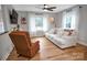 Cozy living room featuring a white sofa, armchair, hardwood flooring, and natural light from the windows at 914 Wyke Rd, Shelby, NC 28150