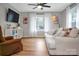 Sunlit living room featuring a comfortable white couch and a view of the outdoors at 914 Wyke Rd, Shelby, NC 28150