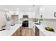 Sleek kitchen with white cabinets, stainless steel appliances and quartz countertops at 2443 Myrtle Ave, Gastonia, NC 28052