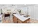 Modern kitchen island with seating, white cabinets and quartz countertops at 2443 Myrtle Ave, Gastonia, NC 28052